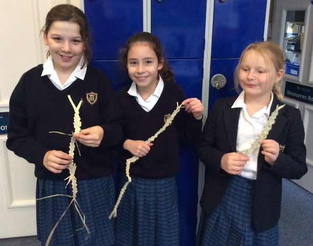 Three Year 5 pupils show off their woven crafts