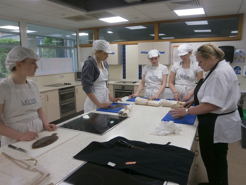 Year 12 students learn to fillet flat fish in Leiths workshop